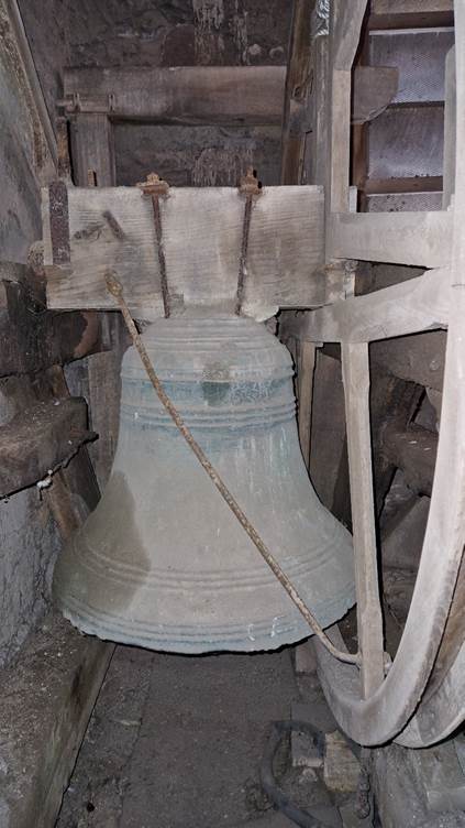 A large bell on a wooden structure

AI-generated content may be incorrect.